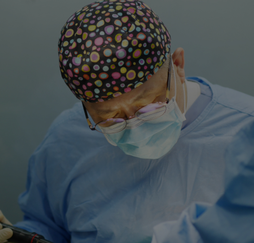 dr abraham an performing his work wearing scrub suit